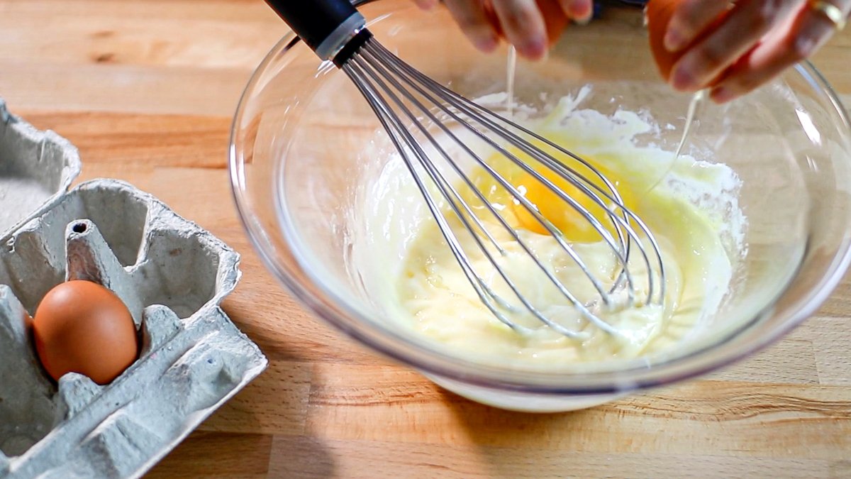 Add the eggs one at a time, mixing well with a whisk after each addition.