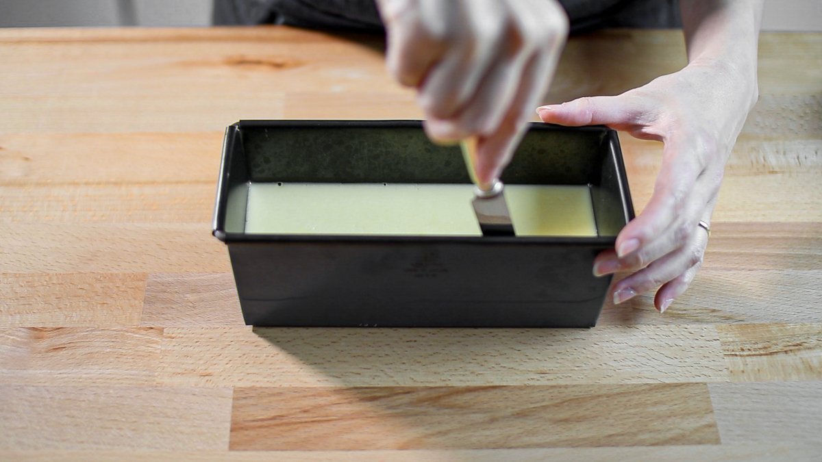 Carefully run a knife along the sides of the mold, making sure to cut down to the caramel layer, to separate the custard from the pan.