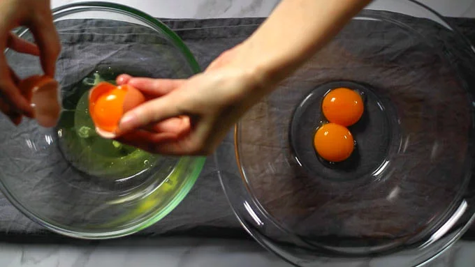 Separate the eggs into yolks and whites and place each in a separate bowl