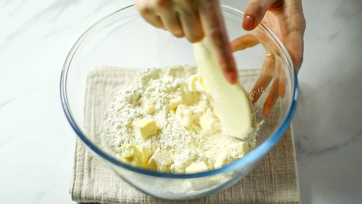 Combine all ingredients in a bowl and mix with a scraper or fork to cut into small pieces You can also mix by hand, but be quick as the heat from your hands will melt the butter