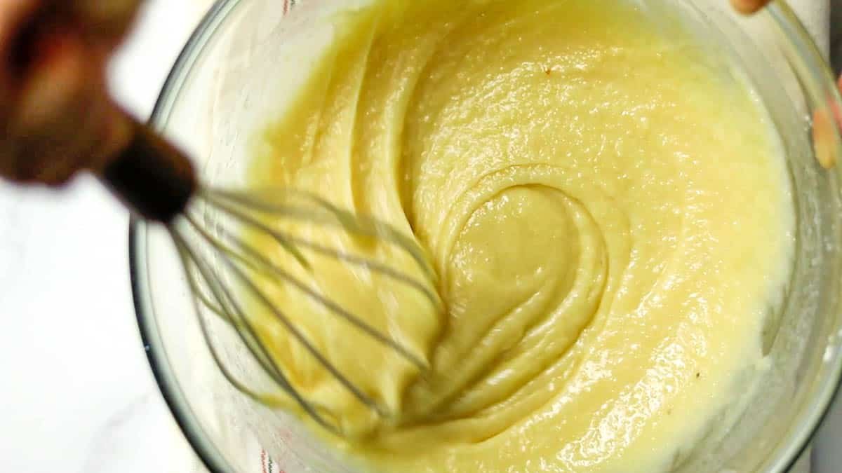 Add melted butter a little at a time, mixing each time Mix until the butter is no longer oily and the dough is smooth Pour the batter into the prepared molds