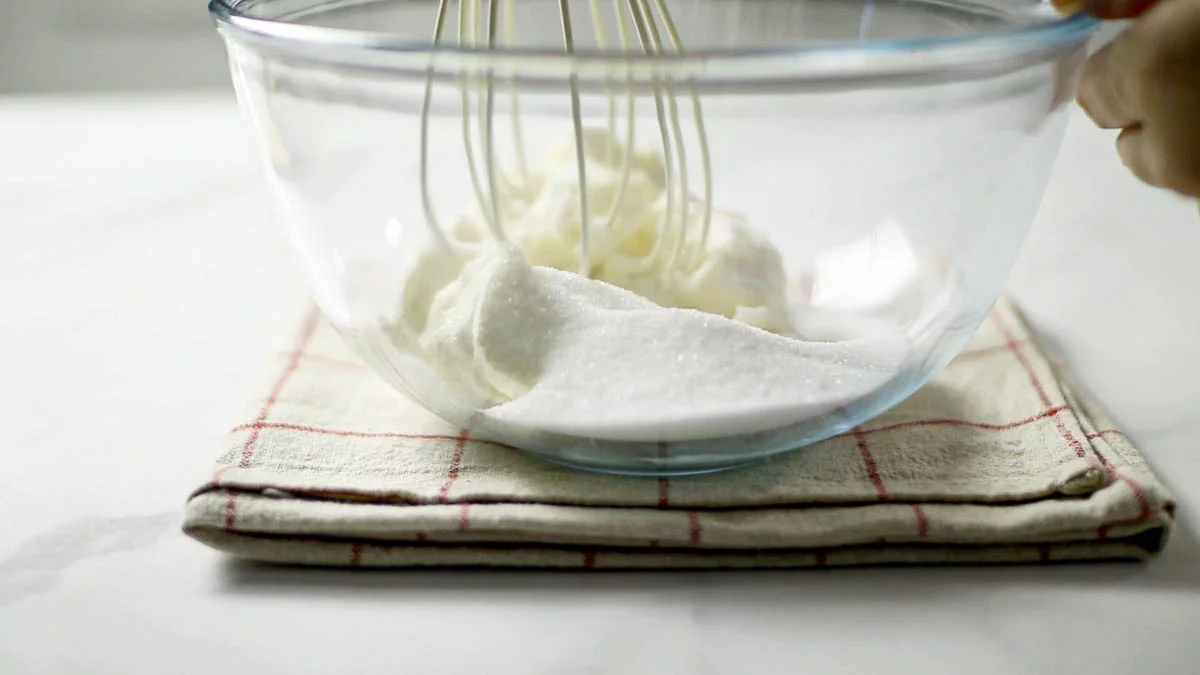 In a bowl, slowly combine cream cheese and granulated sugar. Add sour cream and mix until combined.