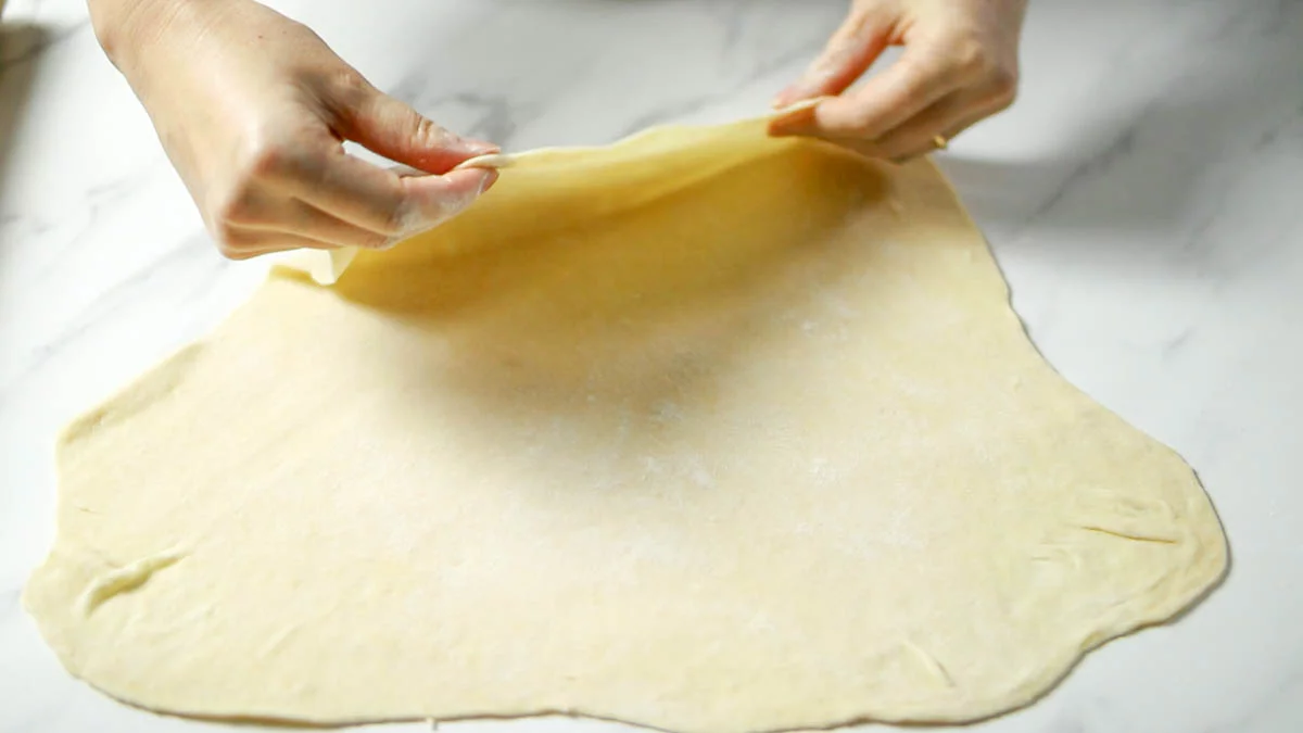 Remove the dough onto a floured platform and 1.Roll out the dough to a thickness of 5 mm (The dough is much thinner than tart dough (The dough should be much thinner than tart dough, as it will puff up when fried, and if it is too thick, it will be hard to the palate)