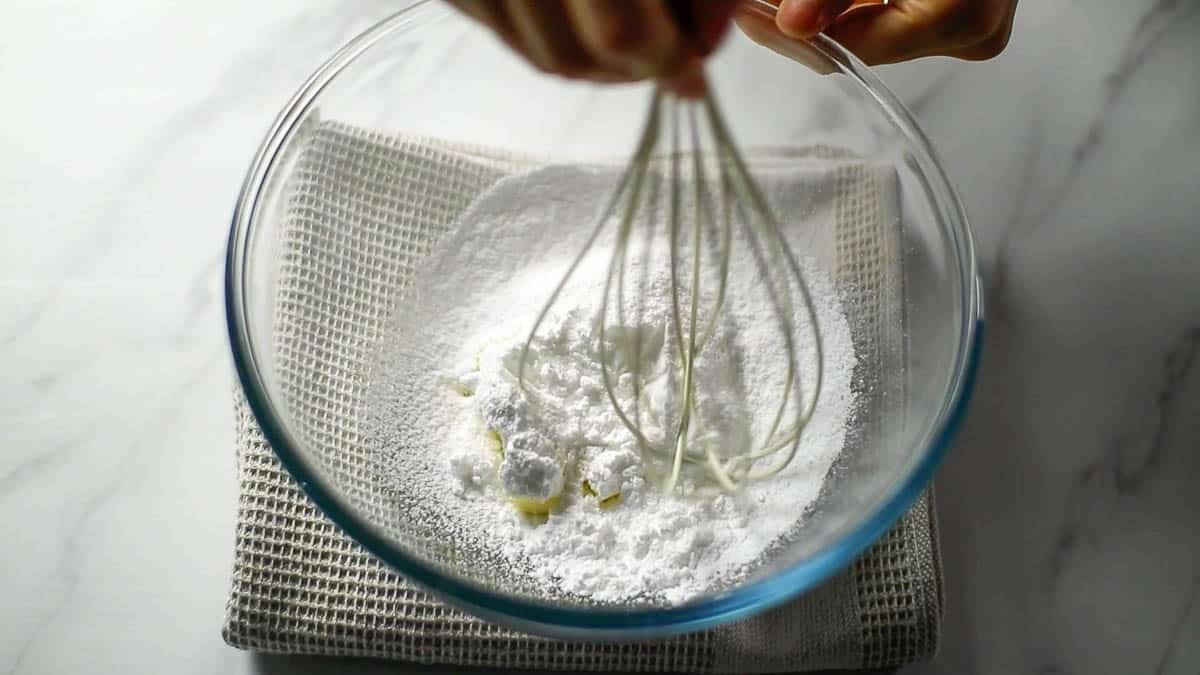 In a bowl, knead the butter to bring it back to room temperature and soften it, then add the powdered sugar and mix well