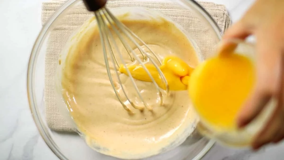 Beat the eggs and add them in two or three batches, mixing well each time