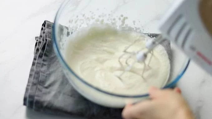 Whisk in the remaining 200 ml of cream to a consistency of 7 parts whipping cream