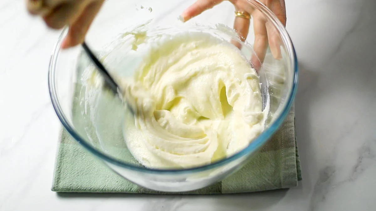 Place cream cheese in a bowl and knead softly with a rubber spatula Once softened, add sugar and mix further