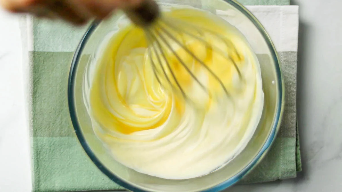 In a separate bowl, mix the sour cream and when smooth, add the Greek yogurt and stir to combineAdd beaten eggs in 3 batches, mixing well each time
