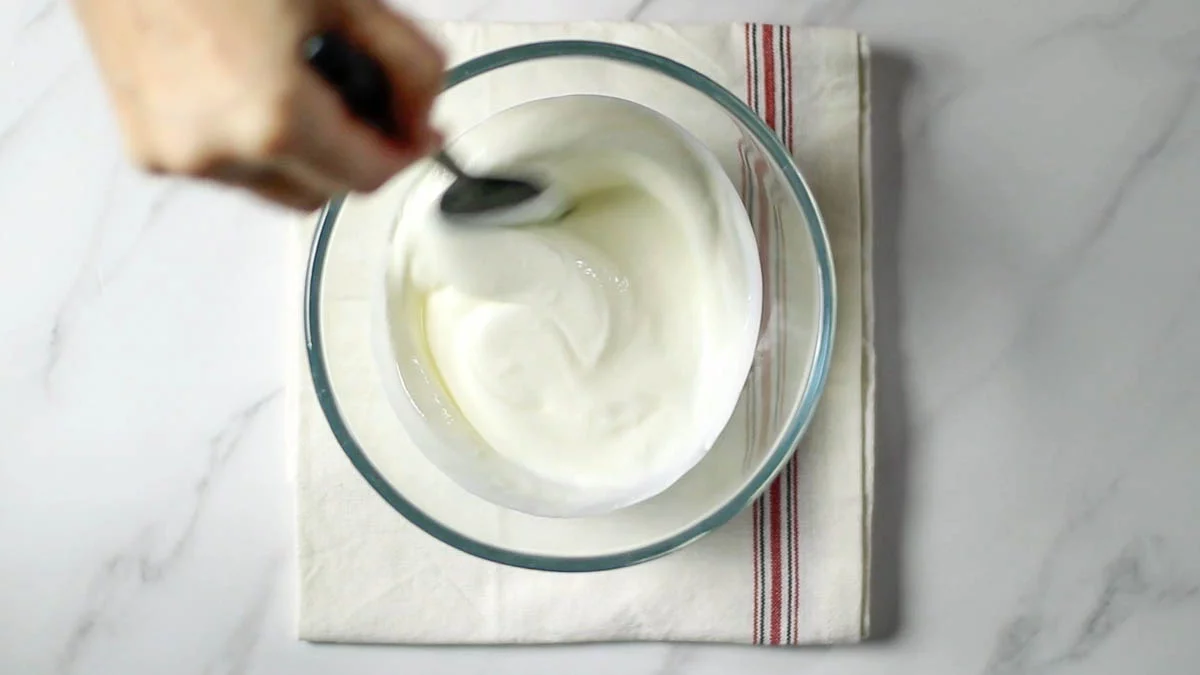 In a bowl, mix yogurt and sugar.