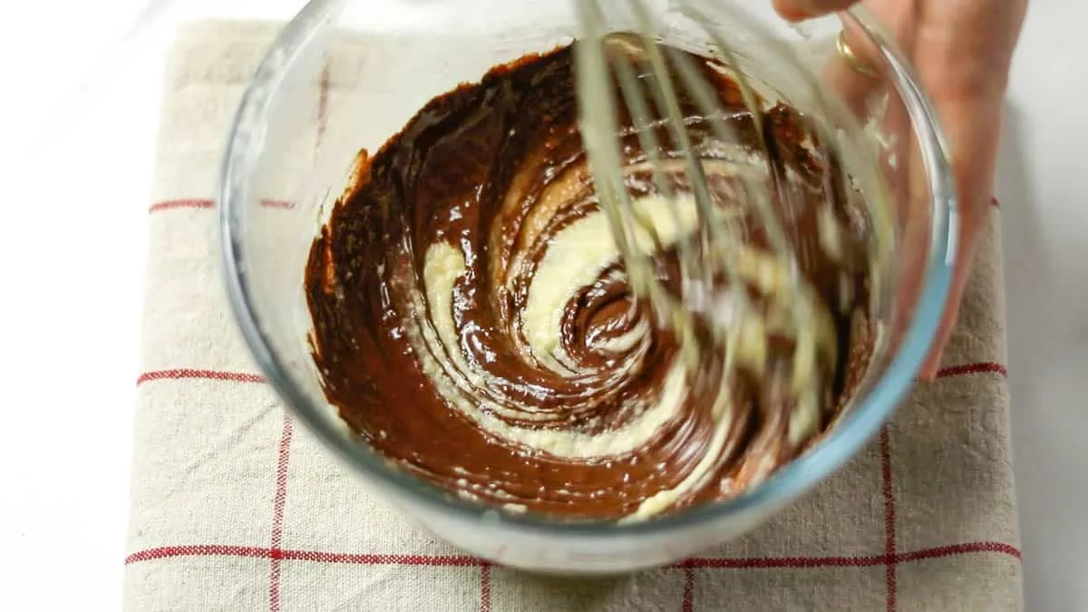 Add the melted chocolate to the mixture and mix well. If desired, add rum and mix it in.