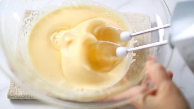 Once the batter becomes pale and slightly thickened, switch to low speed. By whisking on low speed, you'll transform the batter, which has increased in volume with large bubbles, into a finer texture with smaller bubbles, creating a more delicate and refined batter.