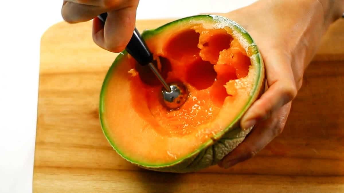 Cut the melon in half and remove the seeds with a spoon Hollow out the melon roundly with a fruit hollowing spoon