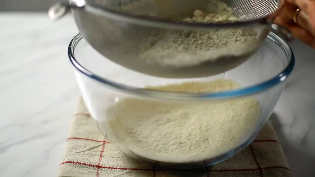 Sift oat flour and baking powder into a bowl