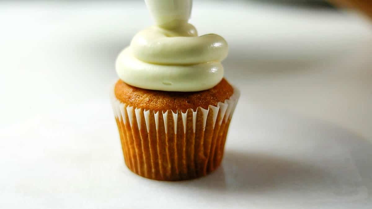 Place in a squeeze bag fitted with a round tip and squeeze out in a circular motion over the muffins