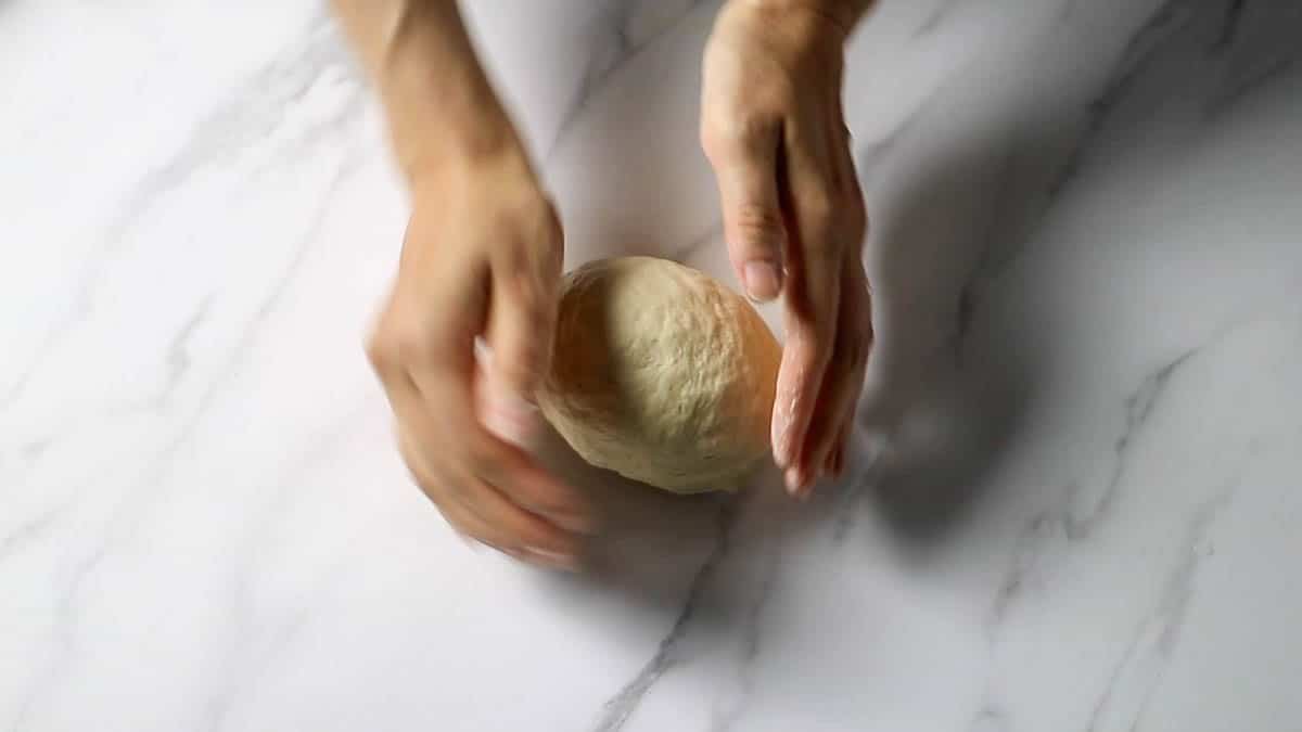 When all the flour has absorbed all the water and is in one lump, remove the dough from the bowl and knead on a lightly floured board until smooth Cover with plastic wrap and let rest in the refrigerator for at least 1 hour (preferably overnight)