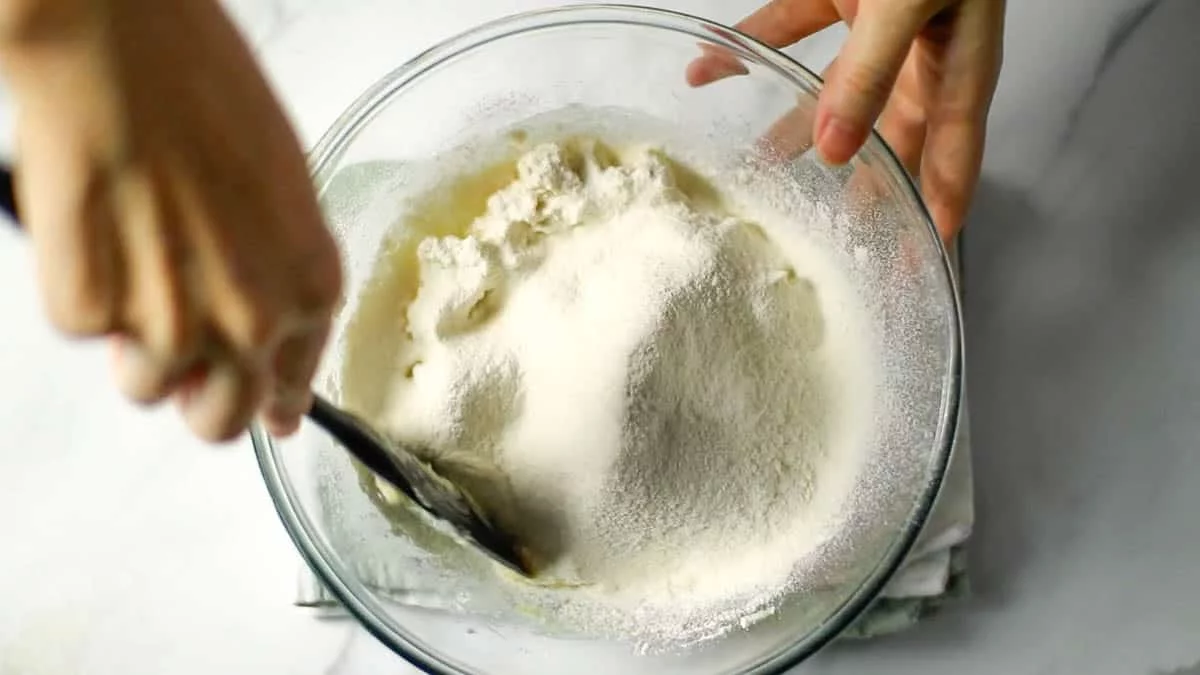 Add sifted cake flour and mix it with a rubber spatula.