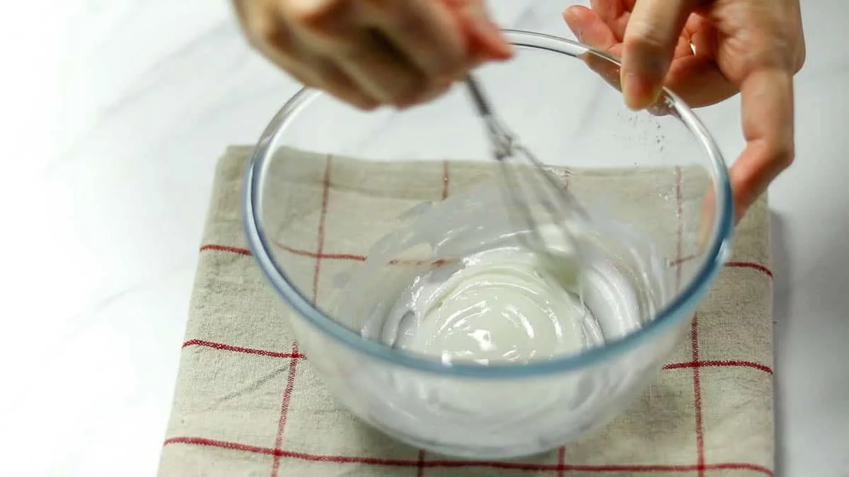 In a bowl, combine the sifted powdered sugar and egg whites with a whipper Make it slightly loose as you will not be drawing lines