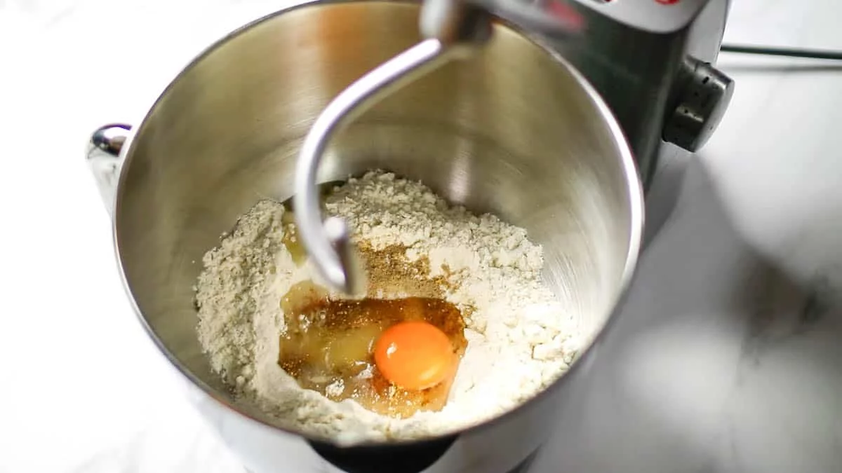 In the bowl of a stand mixer, combine the strong flour, granulated sugar, cinnamon, cardamom, nutmeg, salt, lemon zest, vanilla extract, eggs, and the milk and instant dry yeast from earlierMix until dough comes together If the dough is soft, add more flour; if the dough is stiff, add more milk