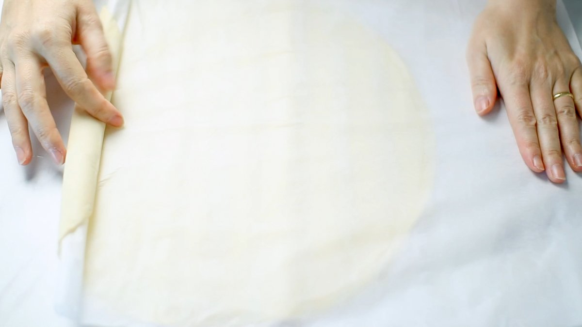 パイシートを広げ、必要であればめん棒でのばします。0.5cmくらいの厚さにのばします。（今回購入したパイシートはとても薄かったので、2枚重ねにして厚さを出しています。）