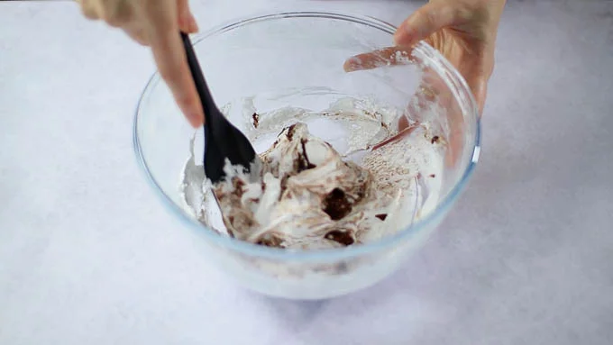 Add melted chocolate and mix quickly (do not overmix) Mix until combined